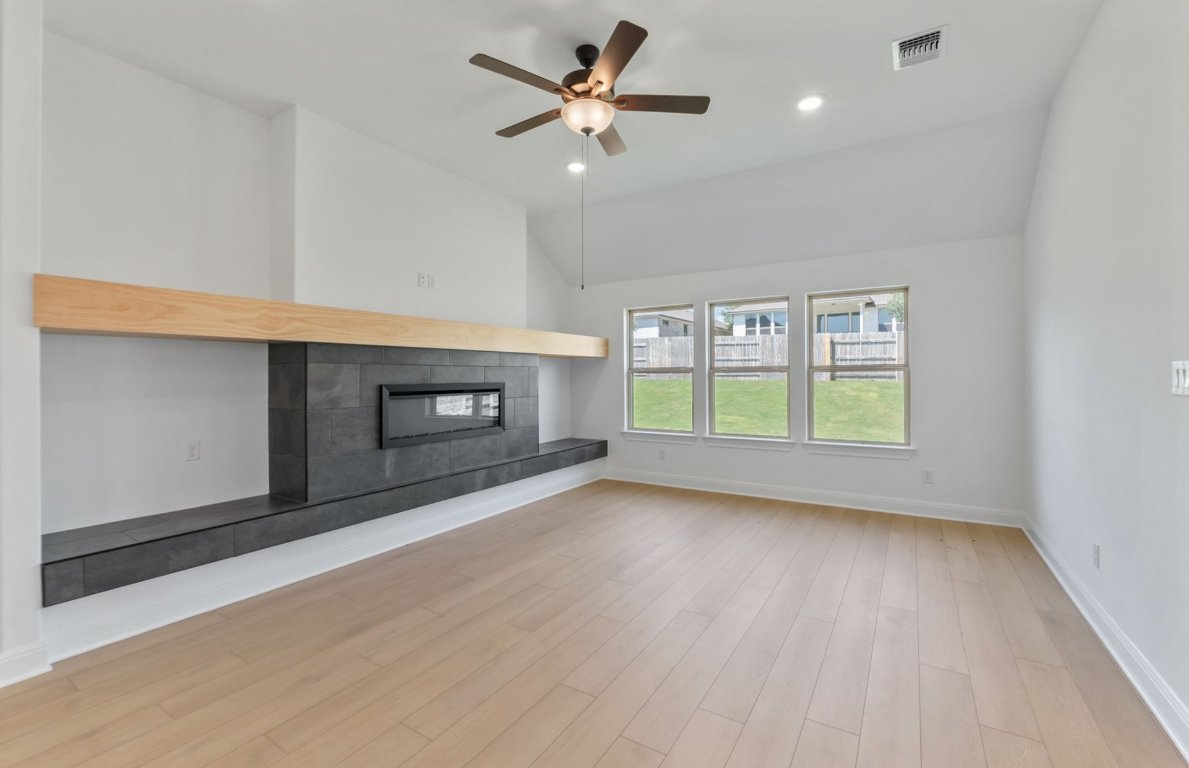 800 Crescent View Drive Georgetown, TX 78628 - Photo 25 of 36 a view of wooden floor fire place refrigerator and window in a room