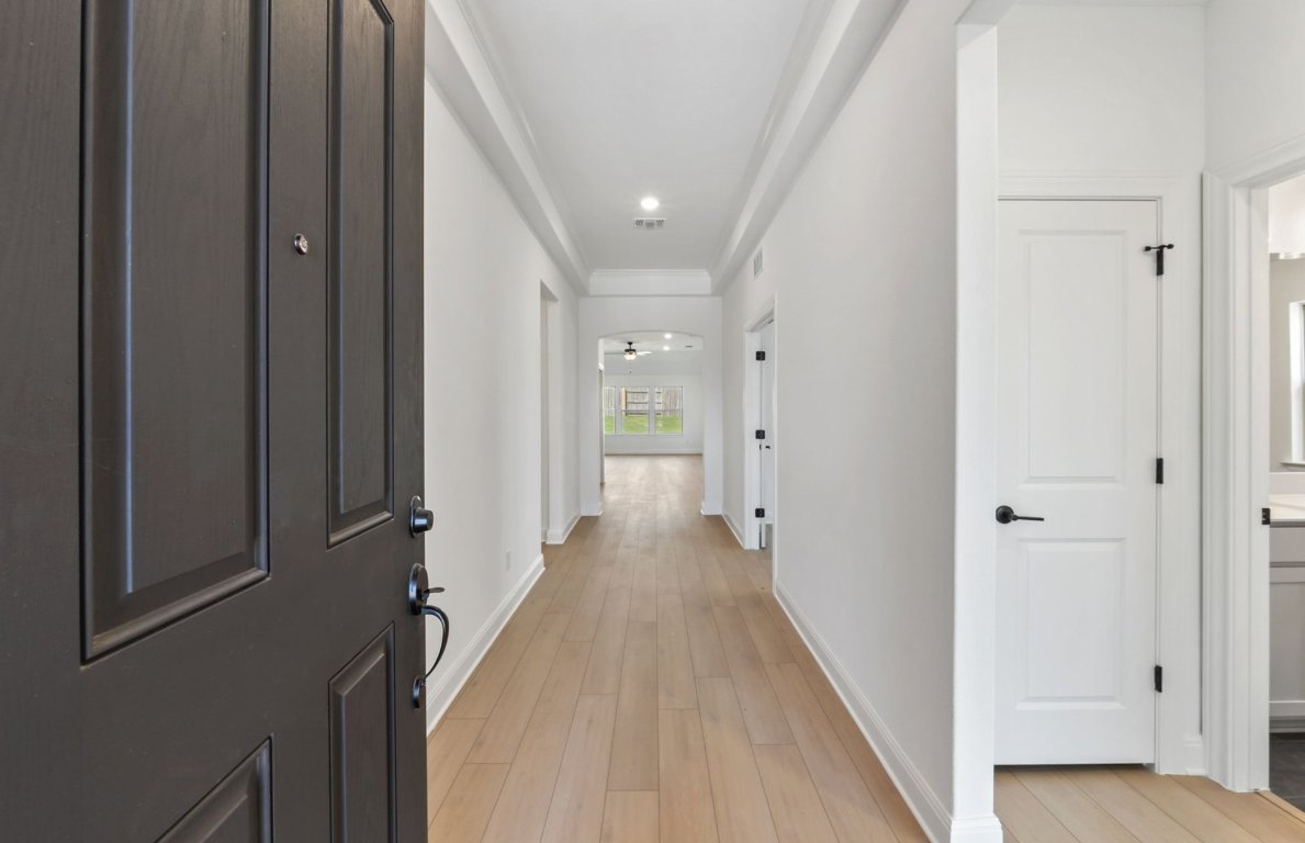 800 Crescent View Drive Georgetown, TX 78628 - Photo 4 of 36 a view of a hallway with wooden floor and staircase