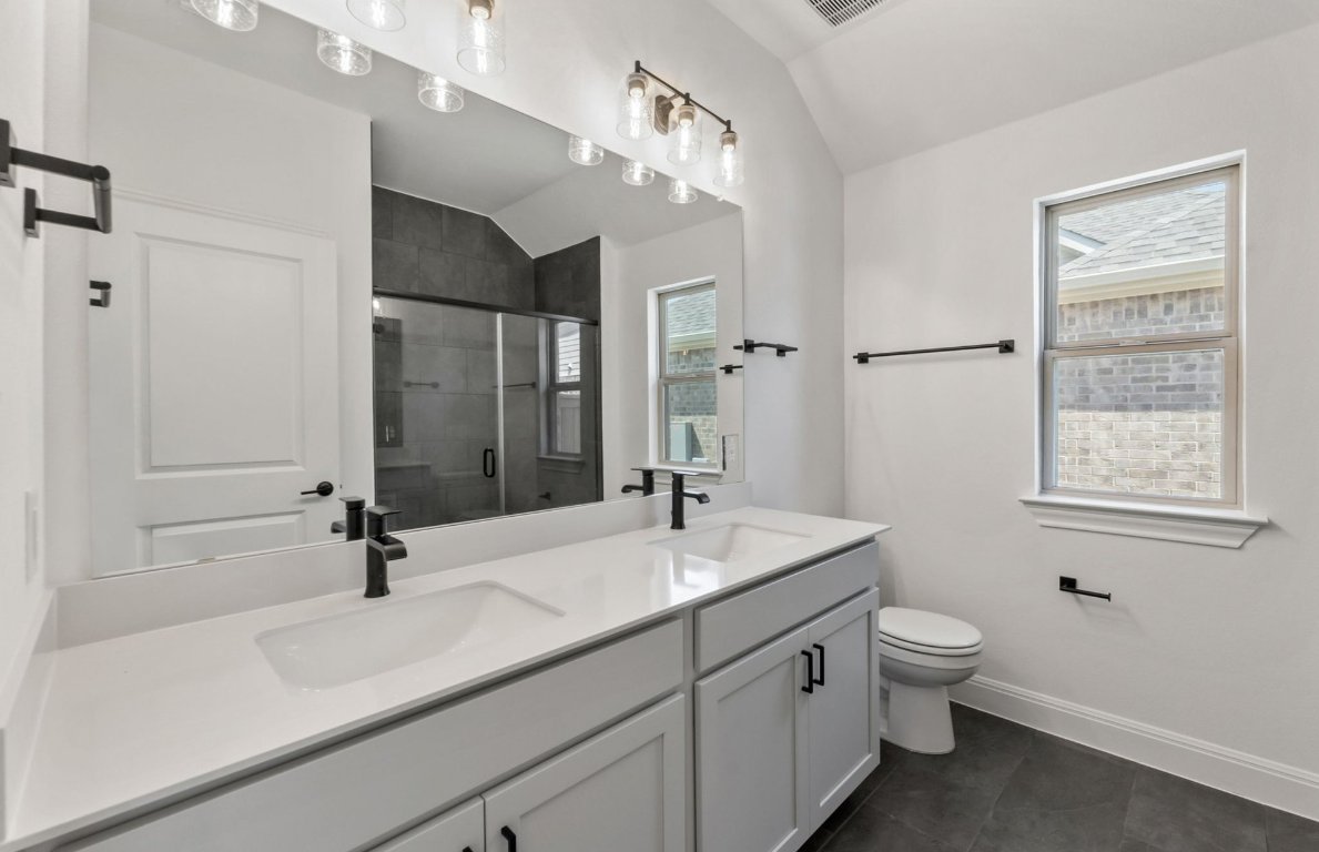 800 Crescent View Drive Georgetown, TX 78628 - Photo 7 of 36 a bathroom with a sink double vanity granite tub shower and a mirror