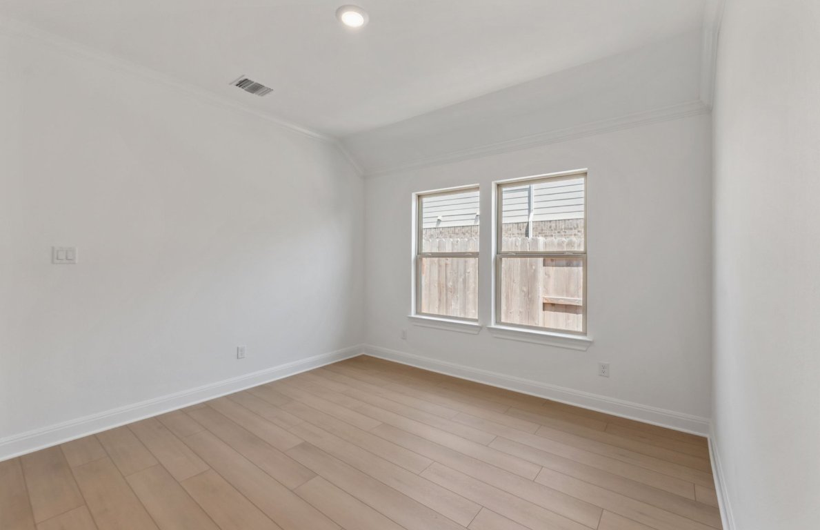 800 Crescent View Drive Georgetown, TX 78628 - Photo 8 of 36 an empty room with wooden floor and windows