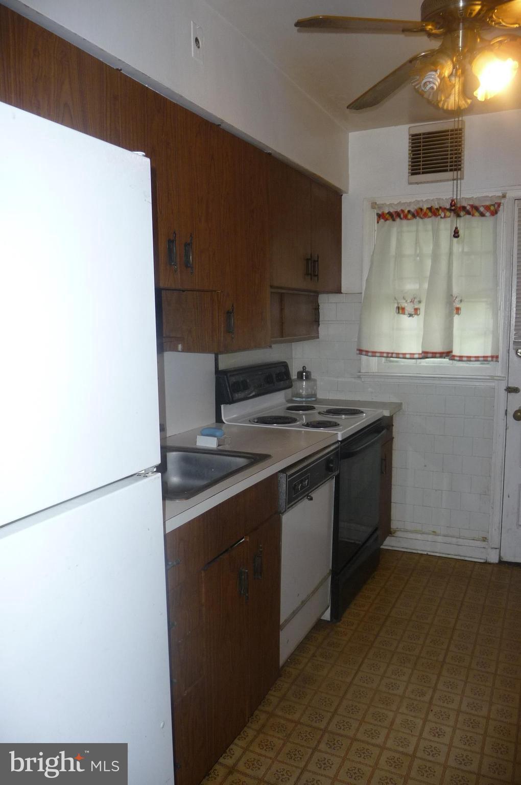 3924 Clarinth Road Baltimore, MD 21215 - Photo 8 of 15 a kitchen with stainless steel appliances granite countertop a sink and a stove