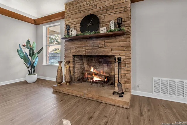 a kitchen with stainless steel appliances granite countertop a sink a stove a refrigerator and island with wooden floor