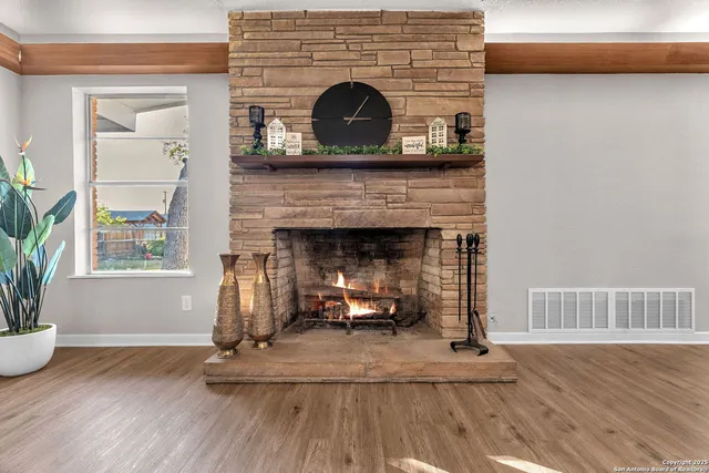 a kitchen with stainless steel appliances kitchen island a wooden floor and chairs