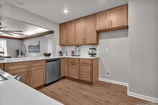a kitchen with stainless steel appliances granite countertop a stove and a refrigerator