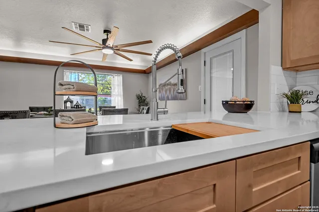 a dining room with furniture a window and a chandelier