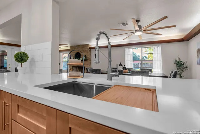 a bedroom with a bed and a ceiling fan