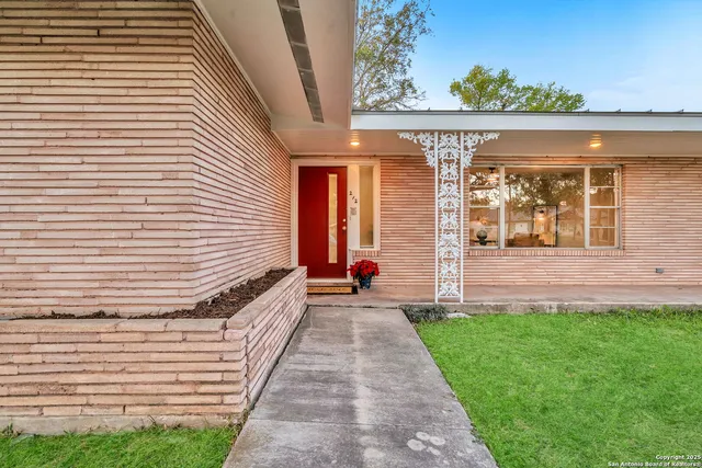 a living room with furniture and baby crib