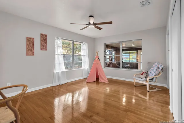 a view of a room with furniture and windows