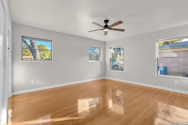 a view of hallway with wooden floor and stairs