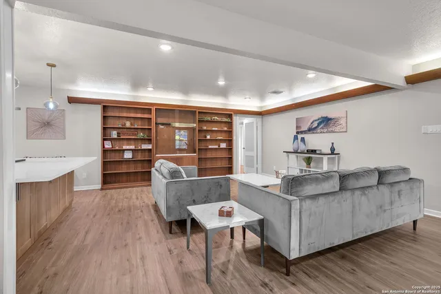 a living room with furniture and a wooden floor