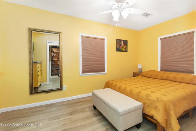 a bedroom with a bed and a couch