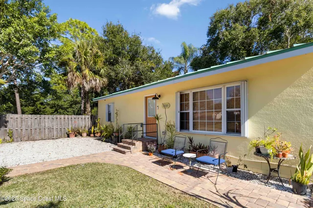a view of a backyard with sitting area