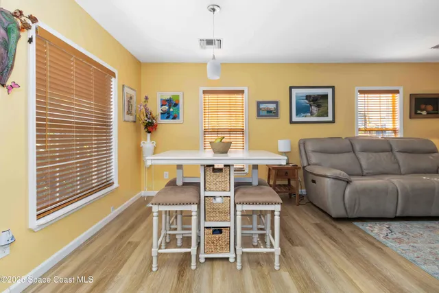 a living room with furniture wooden floor and a window
