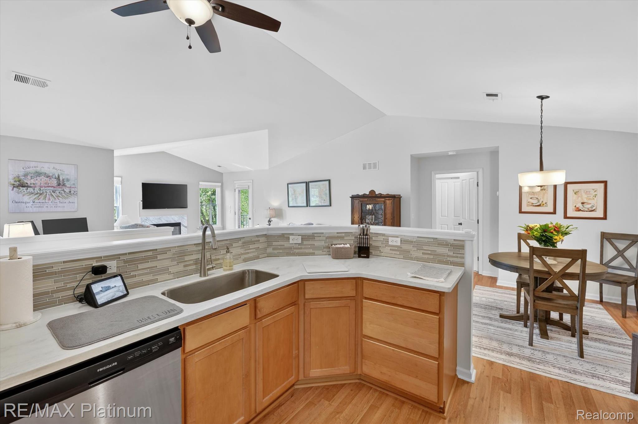 4191 Hampton Ridge Boulevard, Unit 41 Howell, MI 48843 - Photo 22 of 23 Kitchen with tasteful backsplash, stainless steel dishwasher, open floor plan, lofted ceiling, and light wood-style floors