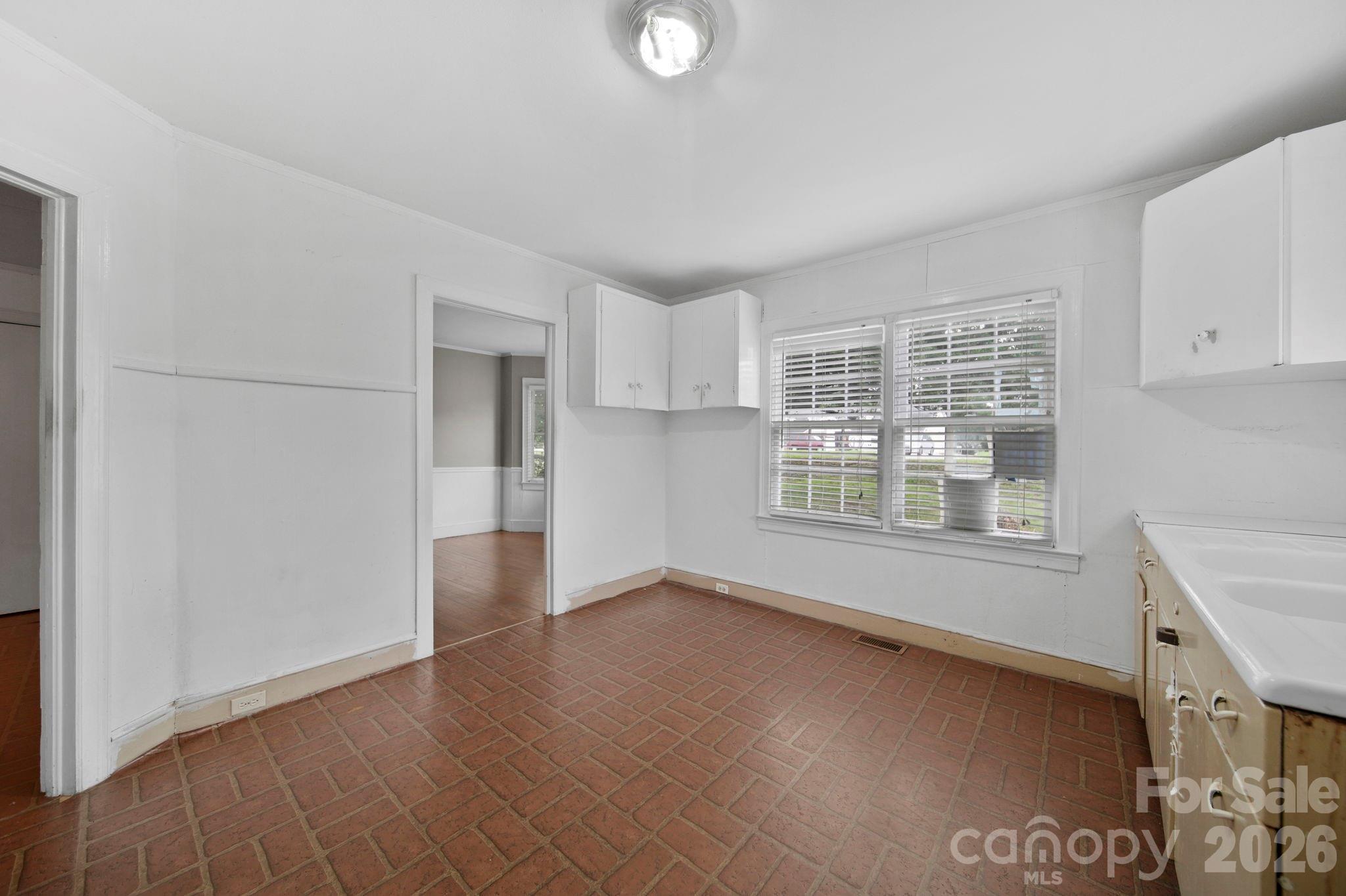 1109 Union Road Gastonia, NC 28054 - Photo 10 of 44 an empty room with windows and cabinet