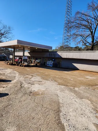 a view of a pool with a lawn chairs under an umbrella