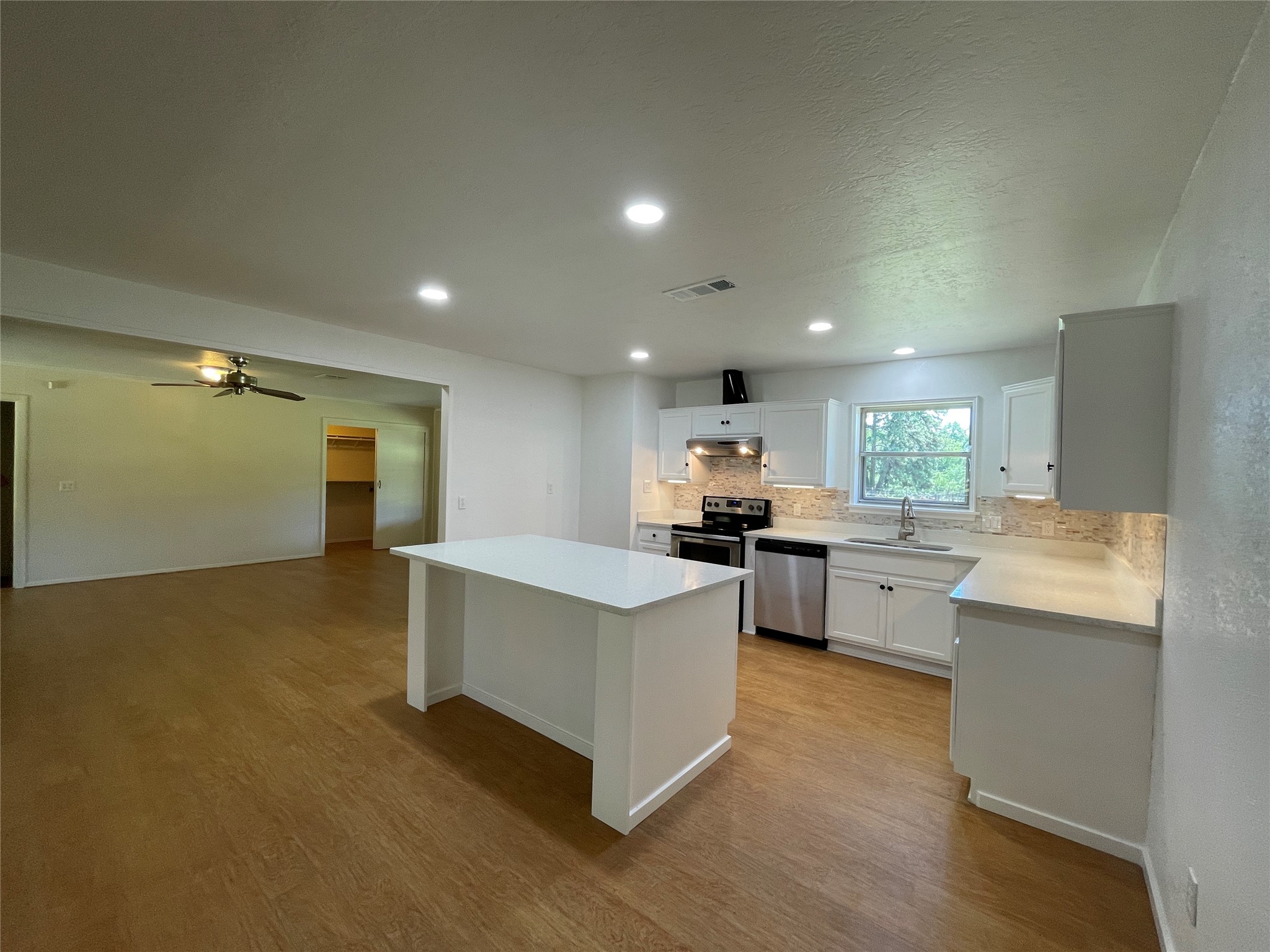 19439 Keenan Cut Off Road Montgomery, TX 77316 - Photo 11 of 39 Discover the heart of the home in this beautifully remodeled kitchen, featuring a chic center island breakfast bar perfect for entertaining and daily living.