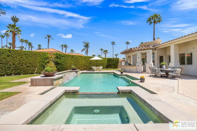 a view of a swimming pool with outdoor seating