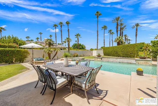 a view of a patio with table and chairs and potted plants