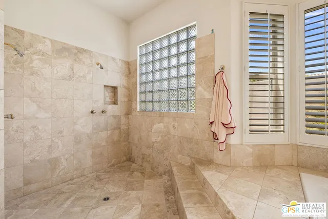 a bathroom with a shower and toilet