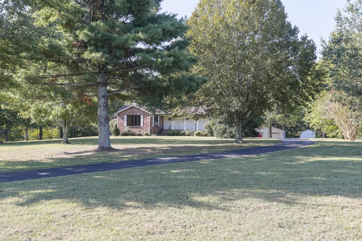 2162 Liebengood Road Goodlettsville, TN 37072 - Photo 2 of 29 Home & acreage surrounded with mature trees creating a beautiful and private surrounding.