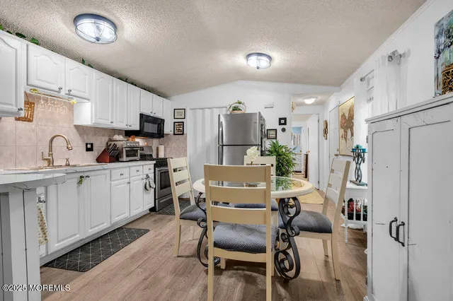 a kitchen with furniture a refrigerator and a sink