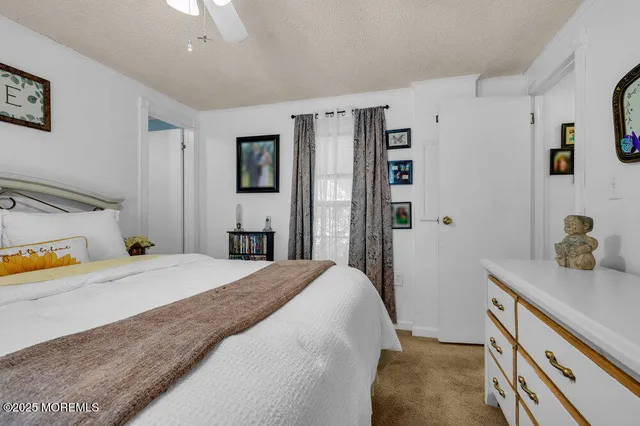 a bedroom with a bed and a dresser in it