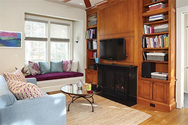 57 Hedge Road Brookline, MA 02445 - Photo 3 of 6 a living room with furniture a flat screen tv and a bookshelf