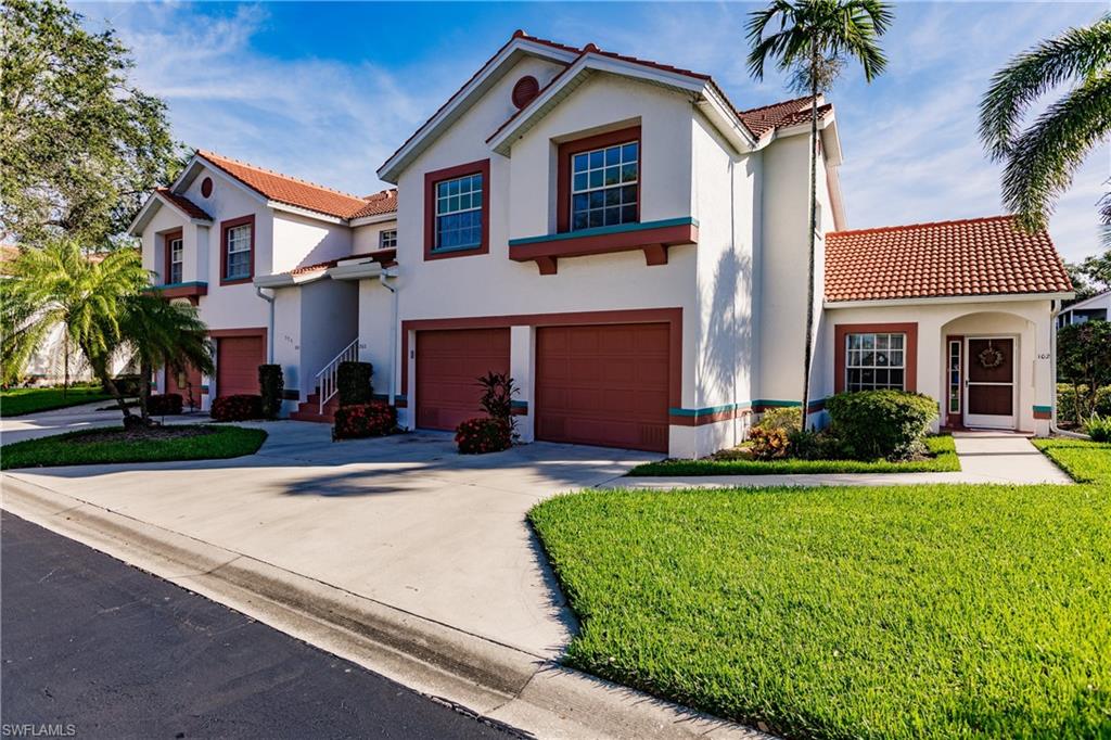 a front view of a house with a yard and garage