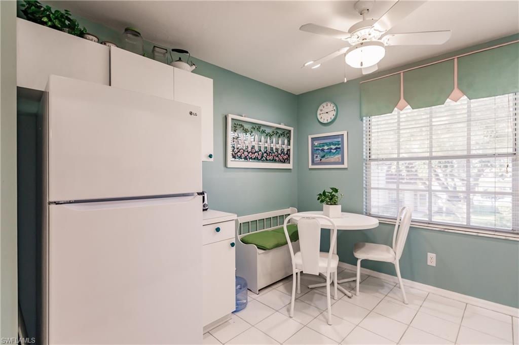 570 Windsor Square, Unit 202 Naples, FL 34104 - Photo 12 of 24 a view of a dining room with furniture window and outside view