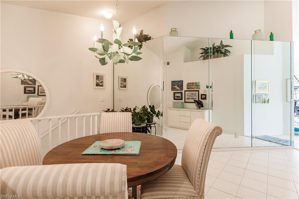 570 Windsor Square, Unit 202 Naples, FL 34104 - Photo 15 of 24 a living room with furniture and a chandelier