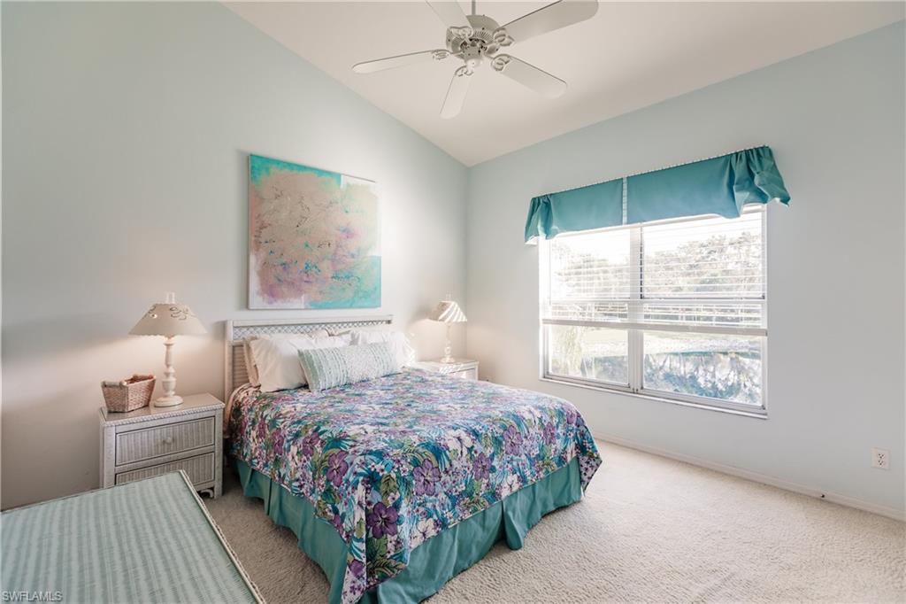570 Windsor Square, Unit 202 Naples, FL 34104 - Photo 16 of 24 a bedroom with a bed and a window