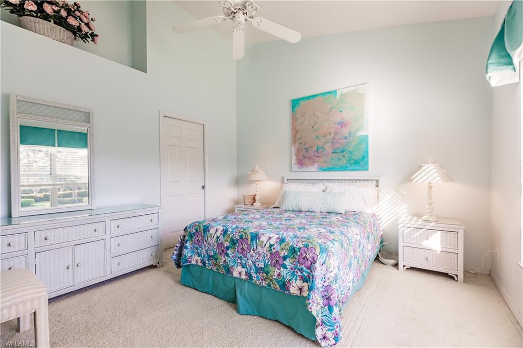 570 Windsor Square, Unit 202 Naples, FL 34104 - Photo 18 of 24 a bedroom with a bed and a window