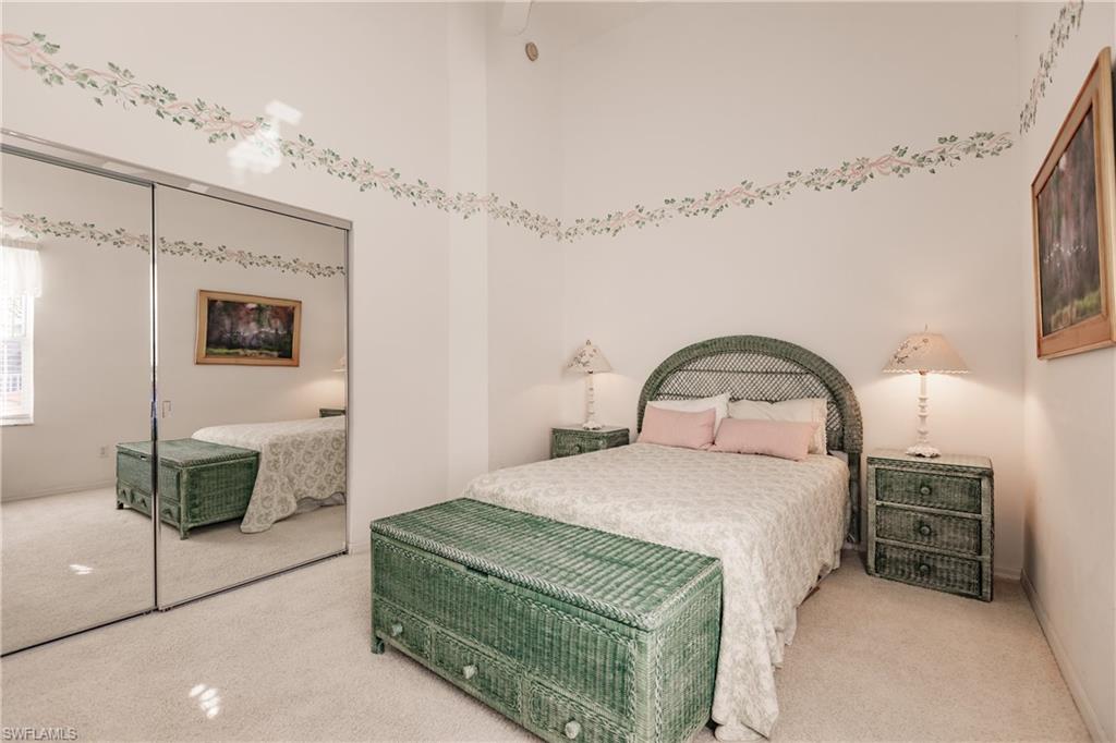 570 Windsor Square, Unit 202 Naples, FL 34104 - Photo 20 of 24 a bedroom with a bed and a dresser