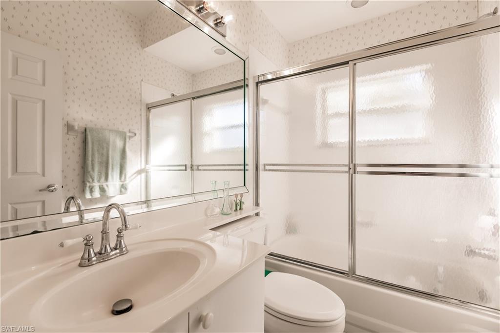 570 Windsor Square, Unit 202 Naples, FL 34104 - Photo 22 of 24 a bathroom with a sink toilet and shower