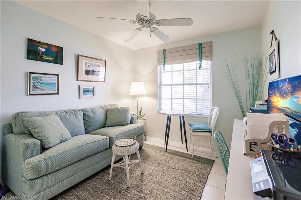 570 Windsor Square, Unit 202 Naples, FL 34104 - Photo 24 of 24 a living room with furniture a flat screen tv and a window