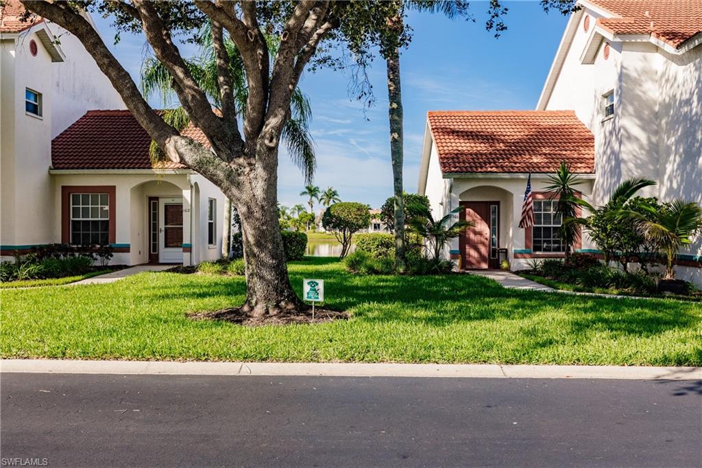 570 Windsor Square, Unit 202 Naples, FL 34104 - Photo 6 of 24 a front view of a house with garden
