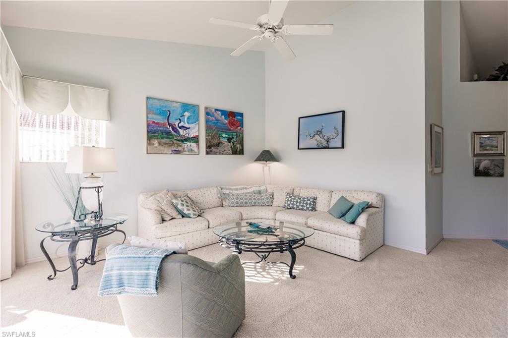570 Windsor Square, Unit 202 Naples, FL 34104 - Photo 9 of 24 a living room with furniture and a painting on the wall
