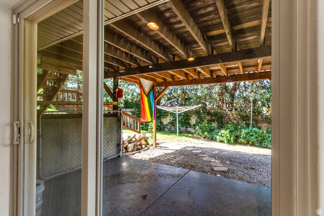 2863 Fallentine Road Sandy, UT 84093 - Photo 33 of 48 Sliding glass door opening to a covered patio with exposed wood joists