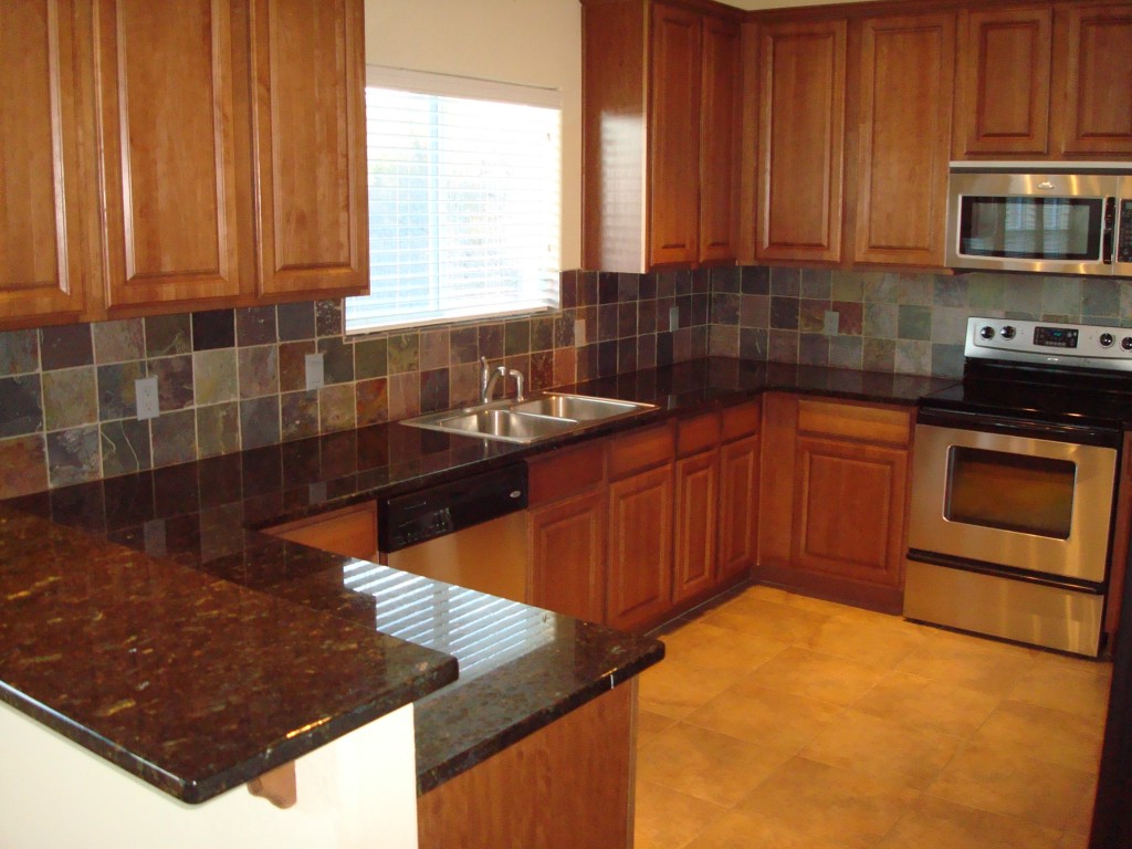 2670 Crazyhorse Pass Austin, TX 78734 - Photo 2 of 27 a kitchen with stainless steel appliances granite countertop a sink stove and cabinets