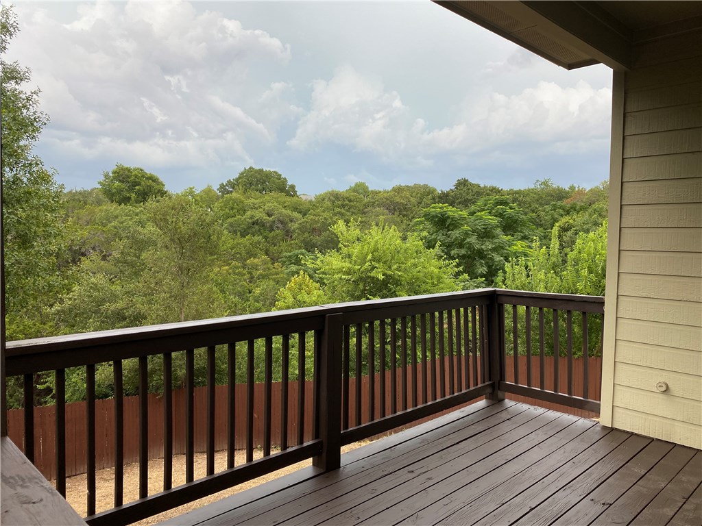 2670 Crazyhorse Pass Austin, TX 78734 - Photo 23 of 27 a balcony with wooden floor and fence