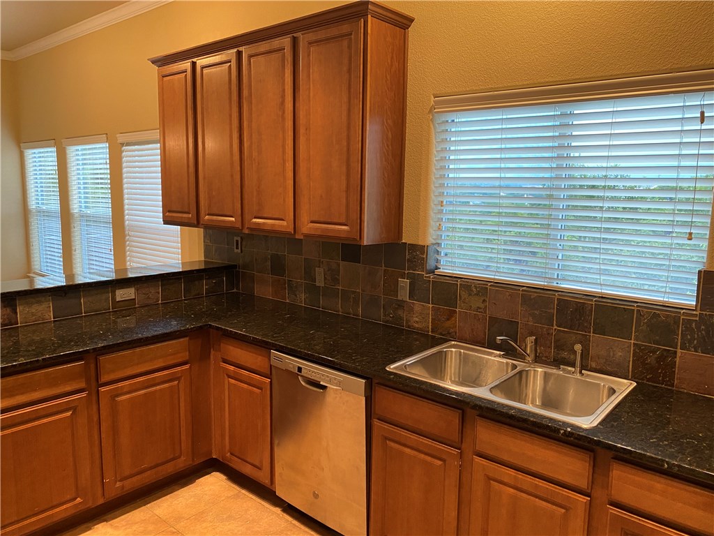 2670 Crazyhorse Pass Austin, TX 78734 - Photo 3 of 27 a kitchen with granite countertop a sink and cabinets