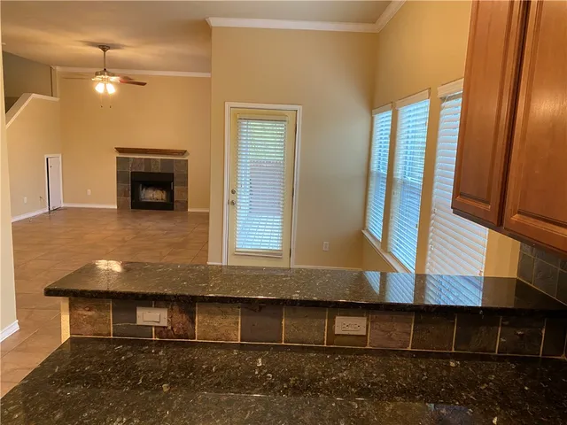 a view of an empty room with a fireplace and a window