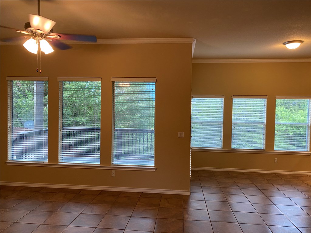 2670 Crazyhorse Pass Austin, TX 78734 - Photo 8 of 27 a view of an empty room with window and chandelier fan
