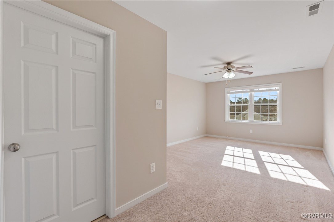 4740 Kennington Park Road Aylett, VA 23009 - Photo 29 of 36 Empty room with ceiling fan and light colored carp