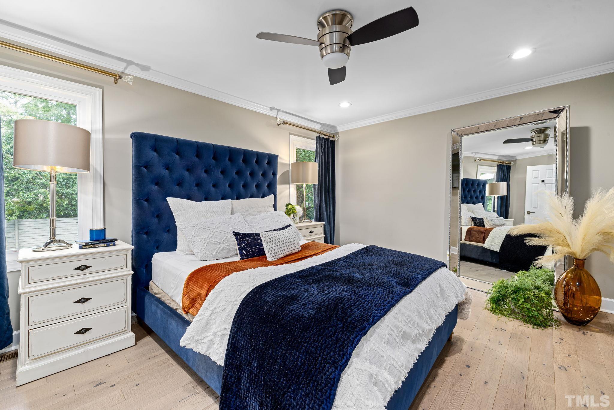 5800 Timber Ridge Drive Raleigh, NC 27609 - Photo 33 of 67 a spacious bedroom with a bed and ceiling fan