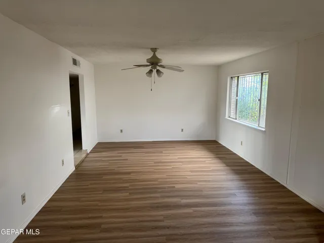 wooden floor in an empty room with a window