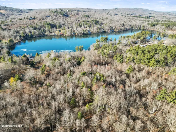 an aerial view of a houses with a lake view