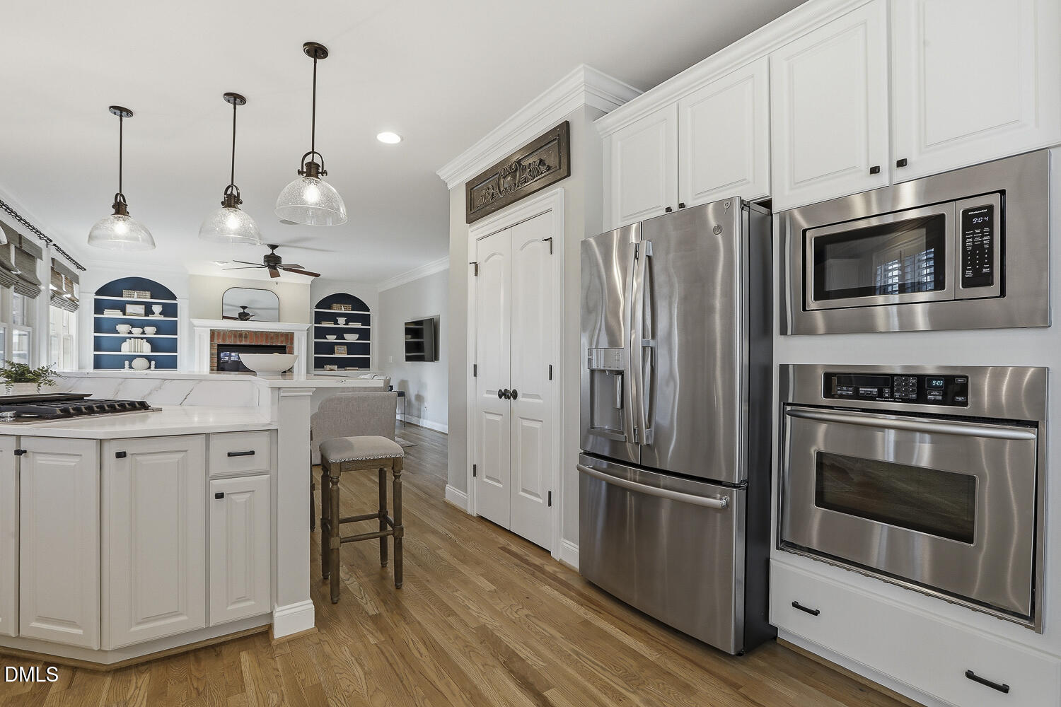 3124 Briar Stream Run Raleigh, NC 27612 - Photo 12 of 57 a kitchen with stainless steel appliances a stove a refrigerator and a wooden floors