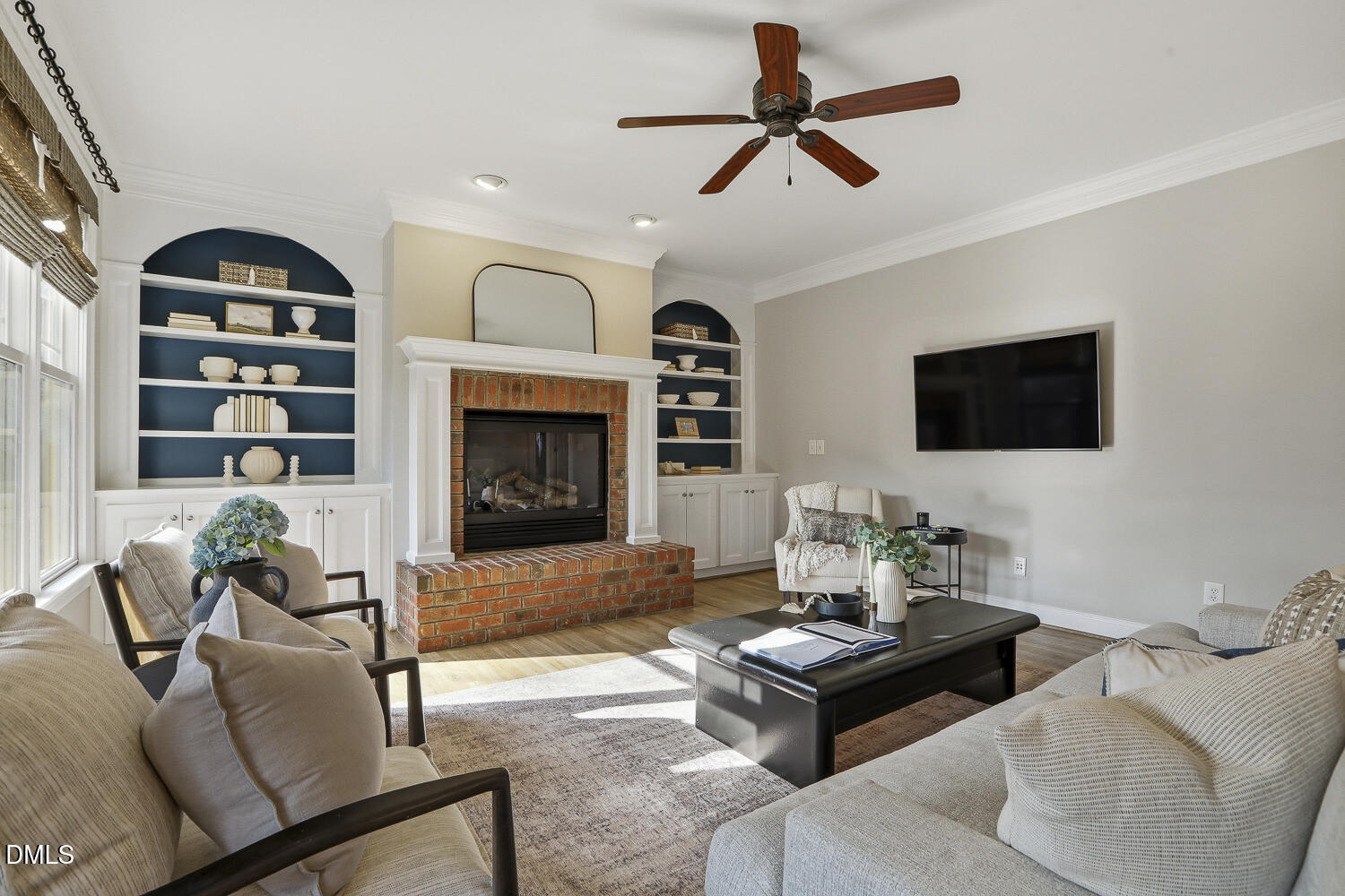3124 Briar Stream Run Raleigh, NC 27612 - Photo 26 of 57 a living room with furniture a flat screen tv and a fireplace